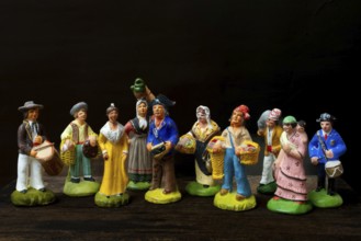 Colorful Provençal terracotta figurines represent traditional characters from rural life. Each
