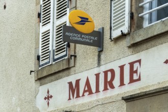 A postal agency sign is seen at the town hall in Auvergne Rhone Alpes, France. This setting