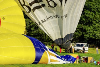 Hot air balloons being prepared for take-off as part of an air show at the Rossfeld in