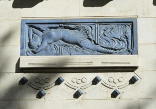 Vichy. A blue relief sculpture is prominently displayed on the wall of a historic building. Thermal