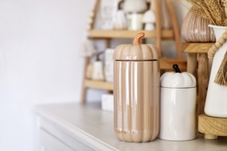 Boho autumn home decor with ceramic pumpkin jars with copy space