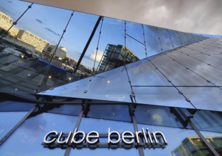 Cube Berlin, cube-shaped office building with inwardly folded glass façade reflecting the