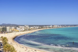 Aerial view at a tourist resort with hotels and tourists on a sand beach at a Mediterranean sea
