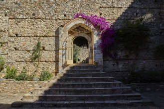Metropolis, Metropolitan Church of Agios Dimitrios Mystras, A flower-covered stone gate in an