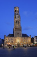 Illuminated Belfry in the historic city centre of Bruges in the evening light, Belfort and City