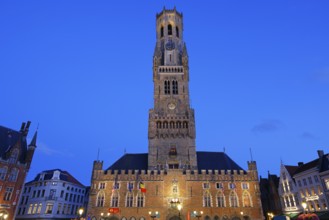 Illuminated Belfry in the historic city centre of Bruges in the evening light, Belfort and City