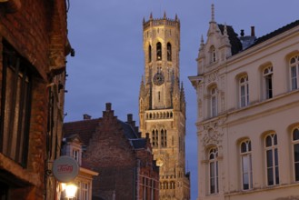 Illuminated Belfry in the historic city centre of Bruges in the evening light, Belfort on the Grote