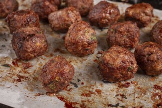 Homemade meatballs cooked to perfection on a baking tray with seasoning and herbs, Swedish