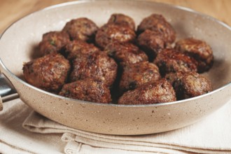 Fried meatballs in a frying pan, homemade, no people