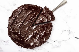 Chocolate cake, round cake, on a marble light table, top view, homemade cakes, no people