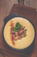 Pumpkin cream soup with shrimp, herbs and spices, homemade, no people