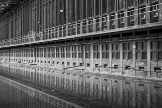 Zollverein coking plant, coke oven batteries are mirrored, water basin, black and white photo,