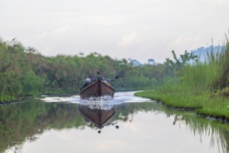 Transport boat, ferry boat with passengers and motorbike between Seeta and Bussi in the Mabamba