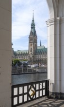 View of Hamburg City Hall through an arcade of the Alster Arcades, Jungfernstieg, Hamburg, Germany