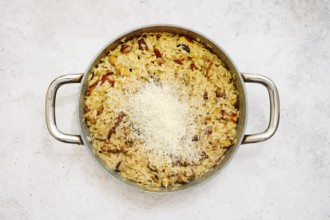 A delicious risoni dish with porcini mushrooms is presented in a pan. This comforting meal is