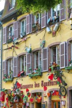 Decorated historic half-timbered house in the old town centre of Colmar, France