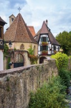 Picturesque Kaysersberg with half-timbered houses on the Weiss river in the old town centre