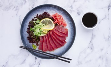 Tuna sashimi, with side dish, on a marble table, homemade, no people