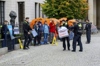 Police officers confiscate boxes from the symbolic house search of the New Generation under the