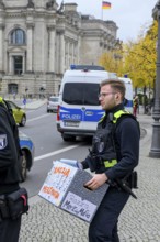 Police officers confiscate boxes from the symbolic house search of the New Generation under the