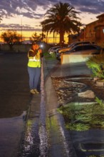 Las Vegas, Nevada - Devyn Choltko, a water waste investigator, patrols a residential neighborhood,