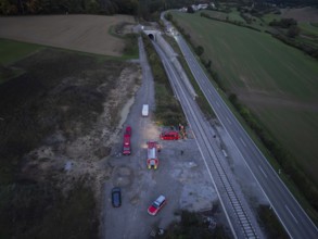 Aerial view of an operation site on railway tracks and roads with fire engines, fire drill in the