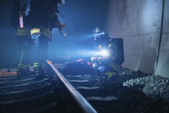 Emergency services on the ground in the tunnel at night, fire brigade exercise in the new tunnel of
