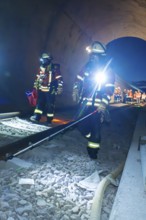 Firefighters during a rescue operation on rails in a tunnel, firefighting exercise in the new