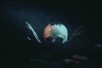 A skull with skeletonised hands bursts out of the earth in the moonlight, Halloween