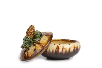 Ceramic jar with pine cones on the lid, white background