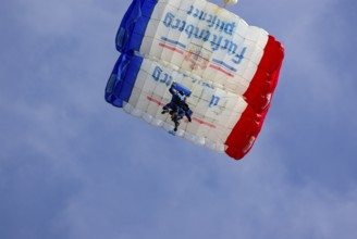 Two parachutists during an aerial acrobatic performance as part of an air show at the Rossfeld in