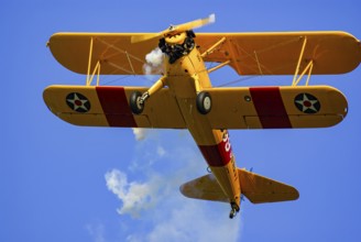 A Boeing-Stearman biplane during a flight demonstration as part of an air show at the Rossfeld in