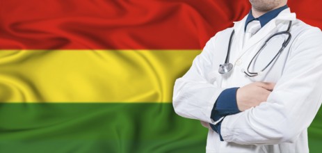 Bolivia healthcare concept. Male doctor on Bolivia flag. Doctor with crossed arms on Bolivia flag