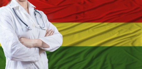 Doctor with crossed arms on Bolivia flag. Bolivia health and care concept. Female doctor on Bolivia