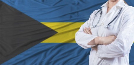 Doctor with crossed arms on Bahamas flag. Bahamas health and care concept. Female doctor on Bahamas