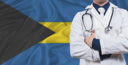 Male doctor with stethoscope on Bahamas flag. Doctor holding stethoscope on Bahamas flag