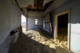 Sand mountains in a former dwelling house, interior photograph, Kolmanskop, restricted diamond