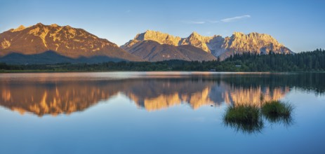 View over the Barmsee to the Karwendel mountains in the evening light, peaks with alpenglow are