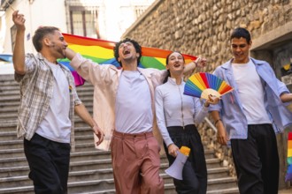 Group of young friends celebrating equality and diversity, walking happily in a city street during