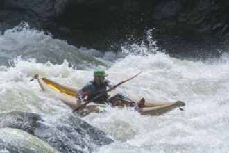 Man kayaking in river, Costa Rica, Central America