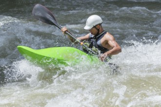 Young man kayaking in river, Costa Rica, Central America