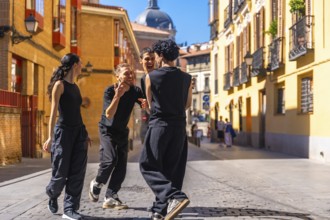 Group of diverse youth smiling, expressing joy and freedom while performing a contemporary dance