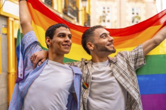 Two smiling men embracing and proudly displaying the vibrant rainbow flag, symbolizing lgbtq plus