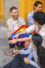 Gen z friends from diverse backgrounds laughing and embracing a rainbow flag outdoors, celebrating