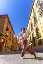 Young man expressing movement and freedom through contemporary dance in an old european city