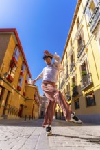 Young man dancer performing a dynamic street dance move in a vibrant old city urban setting under a