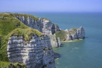 View of the Falaise d'Amont rock arch, hike from Yport to Etretat along the chalk cliff coast,