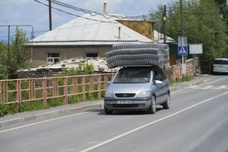 A car carrying goods on its roof, driving along an urban road, Geghhovit, Geghahovit, Verin