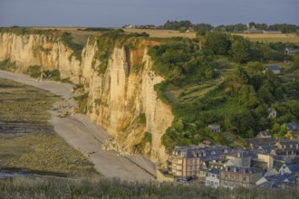 View of the village and the chalk cliffs in the evening light, Yport, Département Seine-Maritime,