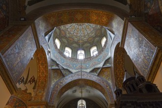 The dome of the church is decorated with ornate patterns and framed by windows, Inside the
